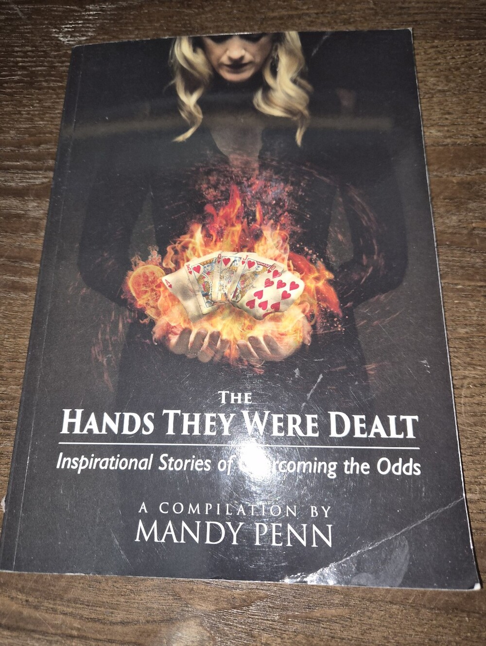 The Hands They Were Dealt by Mandy Penn - Black Cover with Fiery Card Graphic